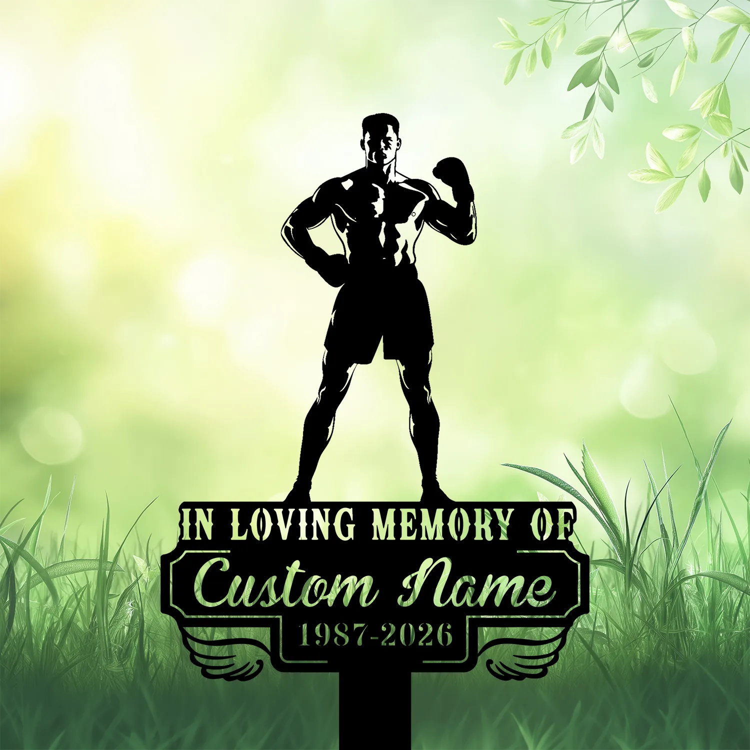 Black silhouette of a muscular boxer statue standing on a memorial plaque in grassy field with soft green bokeh background; plaque reads "In Loving Memory of Custom Name 1987-2026"