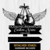 5a-3 Black metal memorial sign showing hanging boxing gloves with wings, text 'In Loving Memory Of', placeholder 'Custom Name' and years '1982-2026' on a white wood background