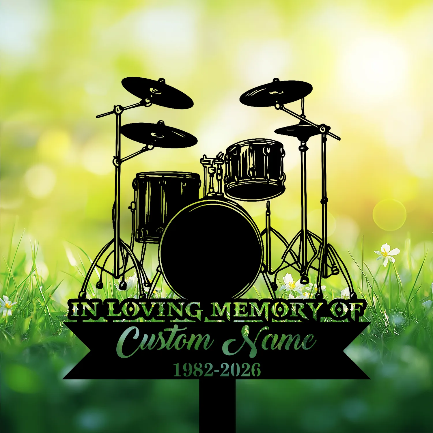 7-3 Black silhouette of a drum set on a memorial sign reading “In Loving Memory,” “Custom Name,” and dates against a sunny grassy bokeh background