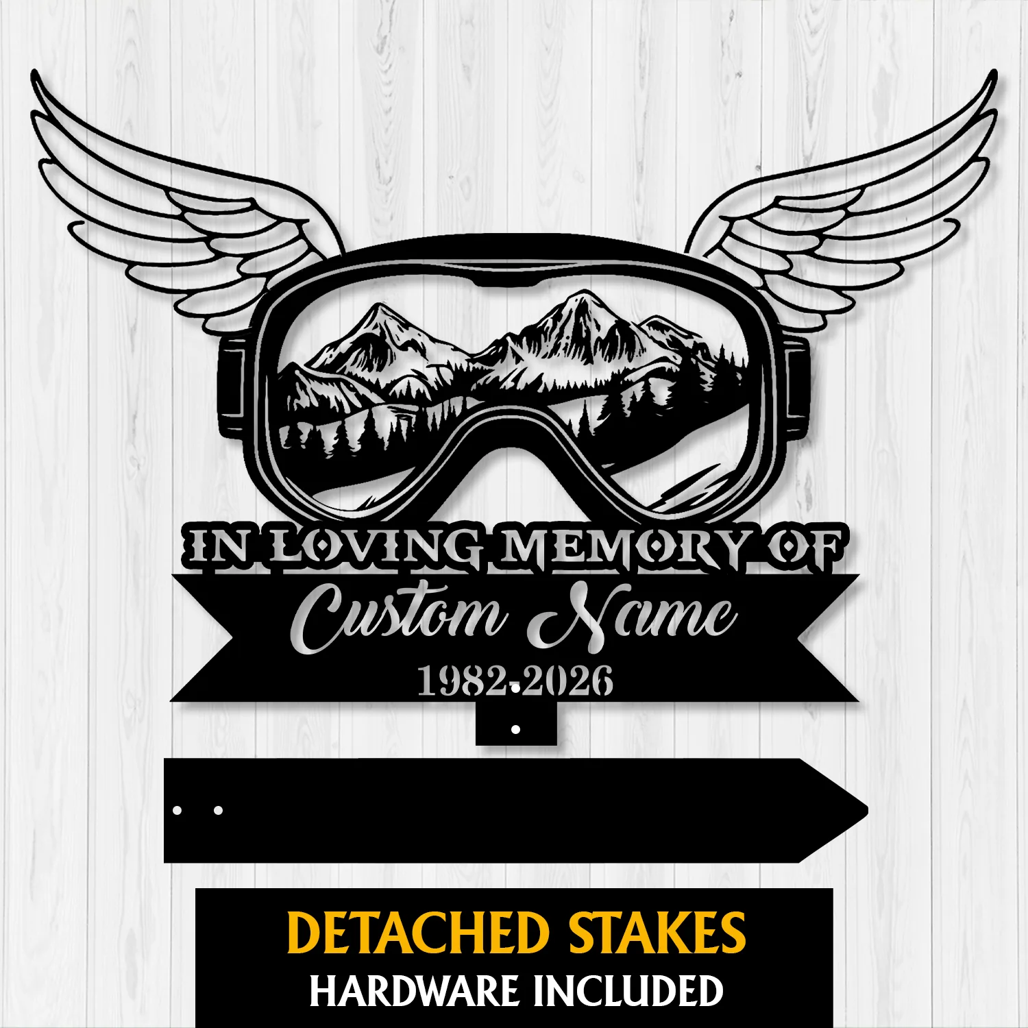 7a-4 Black memorial sign shaped like ski goggles with wings, mountain landscape inside lens, text reading "In Loving Memory of Custom Name 1982-2026" on white wood background