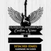 Black silhouette memorial sign of an electric guitar with angel wings over text reading "In Loving Memory of" and placeholder "Custom Name 1982-2026" on a light wood background.