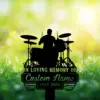 Silhouette of a drummer at a drum kit with memorial text reading "In Loving Memory of Custom Name 1987-2026" over a bright green grassy bokeh background
