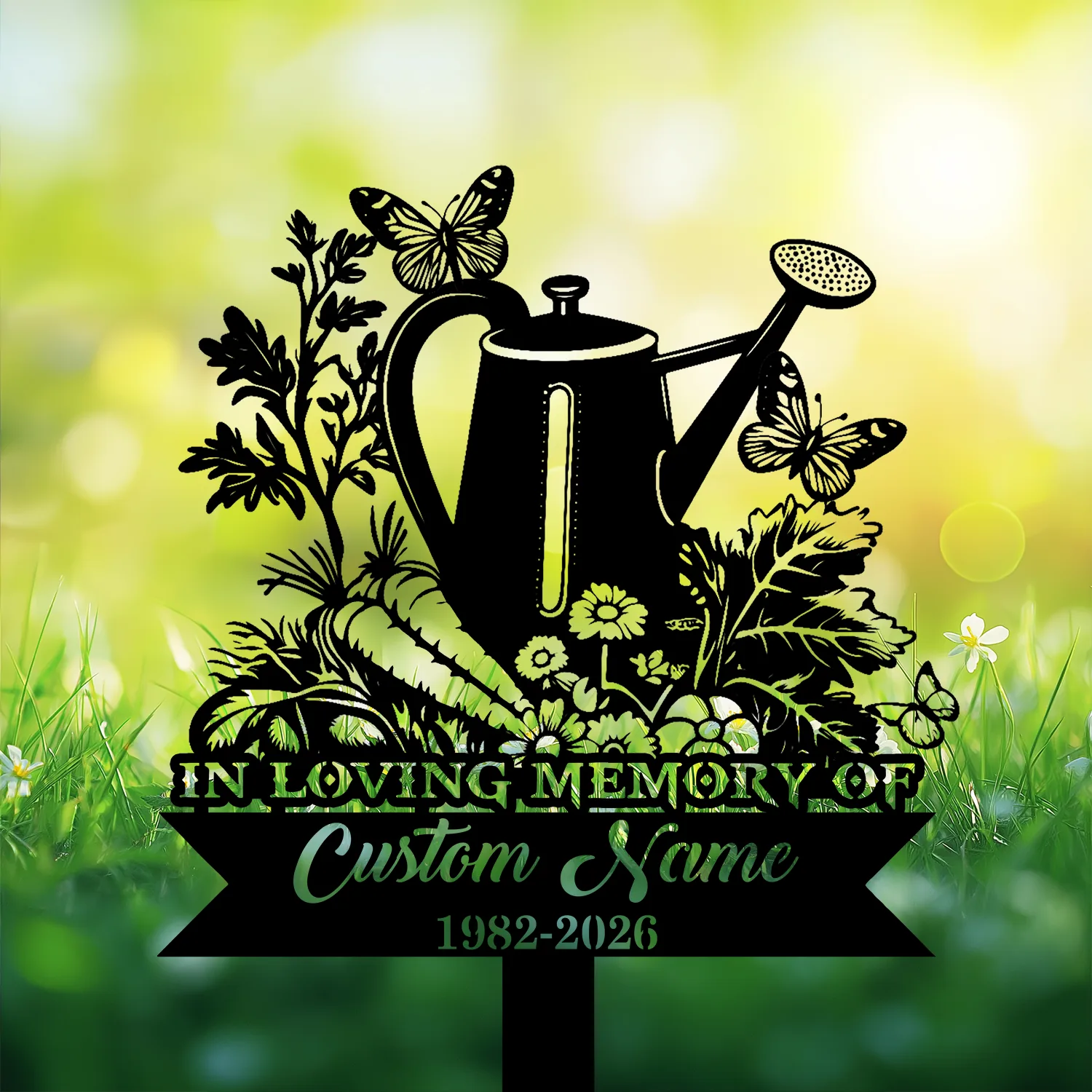 9-2 Black silhouette memorial stake with a watering can, flowers, butterflies and text reading "In Loving Memory" and customizable name and dates against a soft green garden background