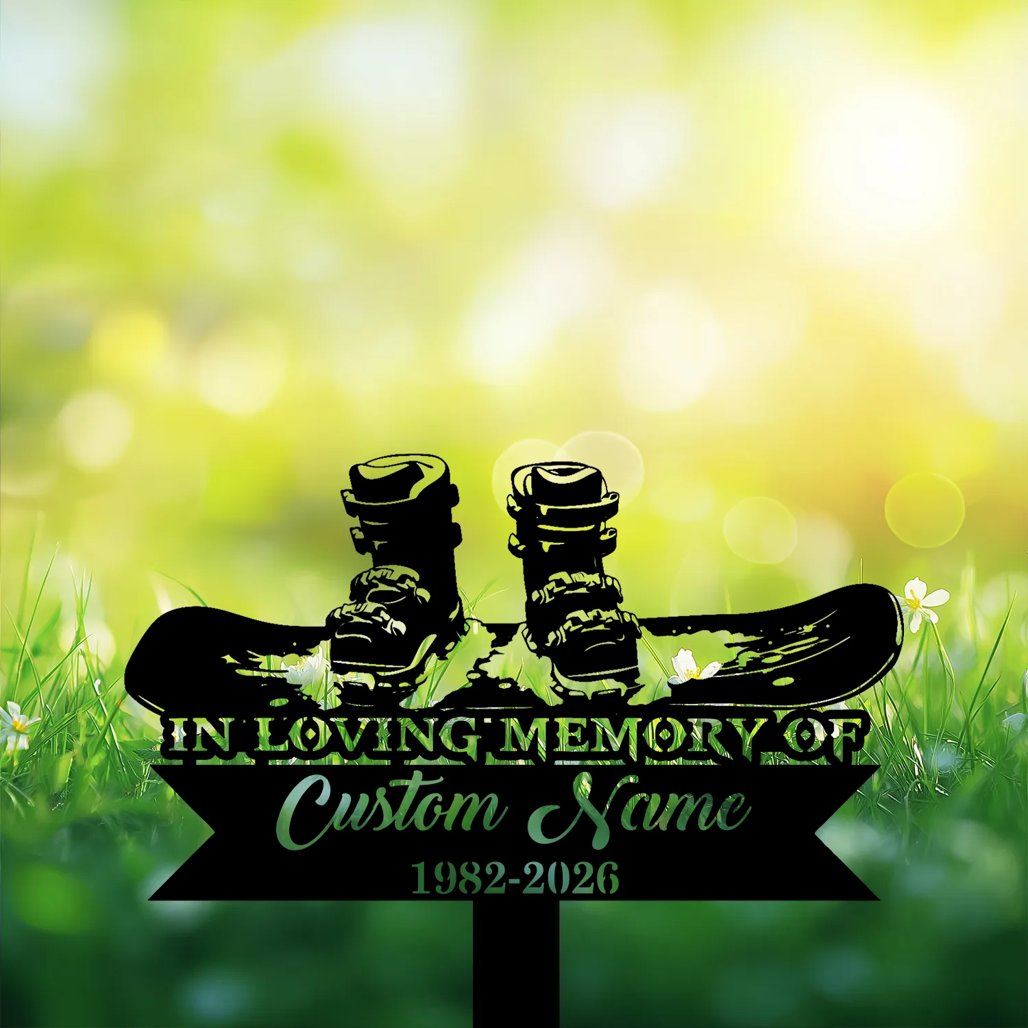 Memorial sign silhouette of snowboard boots and board reading "In Loving Memory of" with placeholder "Custom Name" and dates 1982-2026 against sunlit grassy background