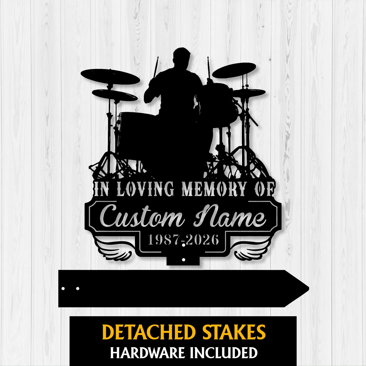 Black silhouette memorial sign of a drummer and drum set mounted on white wood background reading "In Loving Memory of Custom Name 1987-2026" with detached stakes shown