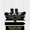 Black metal memorial sign with snowboard and boots graphic, text reading "In Loving Memory of" and placeholder "Custom Name" with dates 1982-2026 on a light wood background