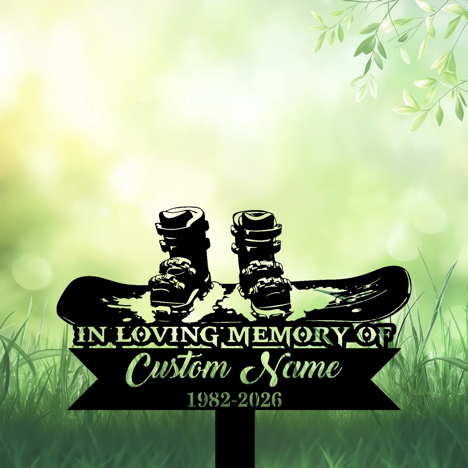 Memorial sign in grass with snowboard and boots silhouette, text reads "In Loving Memory of Custom Name 1982-2026" on a soft green bokeh background