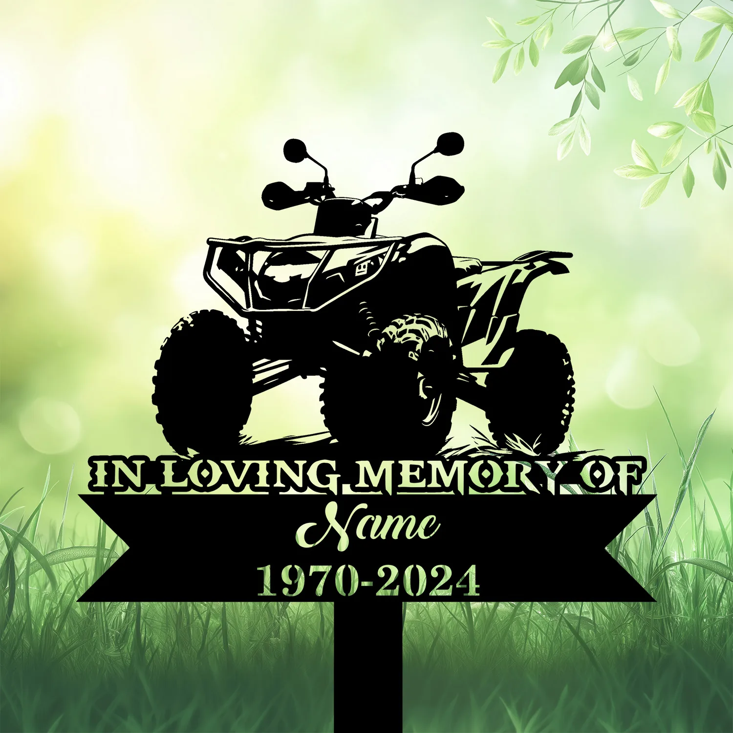 Black silhouette memorial sign of an ATV with text placeholder "In Loving Memory of Name 1970-2024" against a soft green grassy background