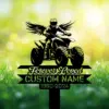 Black silhouette of a winged ATV rider above ribbon text reading "Forever Loved" and placeholder "CUSTOM NAME 1960-2024" over blurred grassy sunrise background