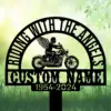 Angel-Biker-3 Black metal memorial sign silhouette of a winged motorcyclist on a cruiser with arched text reading “RIDING WITH THE ANGELS” and placeholder “CUSTOM NAME” over grassy green background, 1954-2024