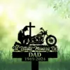 Biker-Kneeling-at-Cross-3 Silhouette memorial sign showing a kneeling motorcyclist beside a cross and bike with text 'In Loving Memory Of' and 'DAD 1949-2024' on a grassy green background.