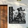 Border-Collie-Sitting-with-Butterfly-1 Black metal house sign mounted on a pale exterior wall beside a wooden door, showing vertical address numbers 1565 and “FAIRWAY DRIVE” with a decorative dog, flowers and butterflies design
