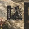 Border-Collie-Sitting-with-Butterfly-2 Black metal address sign on a brick exterior showing numbers 1565, a dog surrounded by flowers and butterflies, and text "FAIRWAY DRIVE"