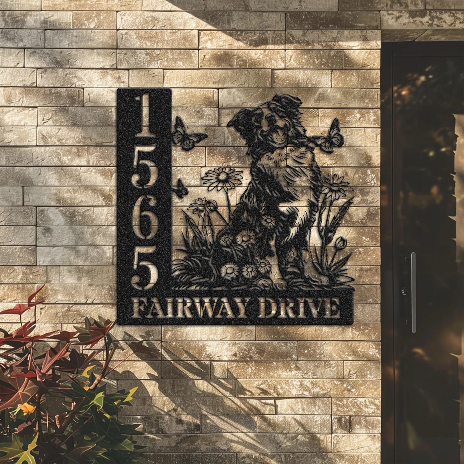 Border-Collie-Sitting-with-Butterfly-2 Black metal address sign on a brick exterior showing numbers 1565, a dog surrounded by flowers and butterflies, and text "FAIRWAY DRIVE"