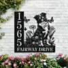 Border-Collie-Sitting-with-Butterfly-4 Black metal house sign on a white brick wall showing address numbers 1565 and text 'FAIRWAY DRIVE' with a dog, butterflies and flowers, surrounded by pink flowering plants