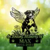Boxer-7 Black memorial garden stake showing a winged dog above flowers with text "In Loving Memory Of MAX 2016-2024" against a sunlit green bokeh background