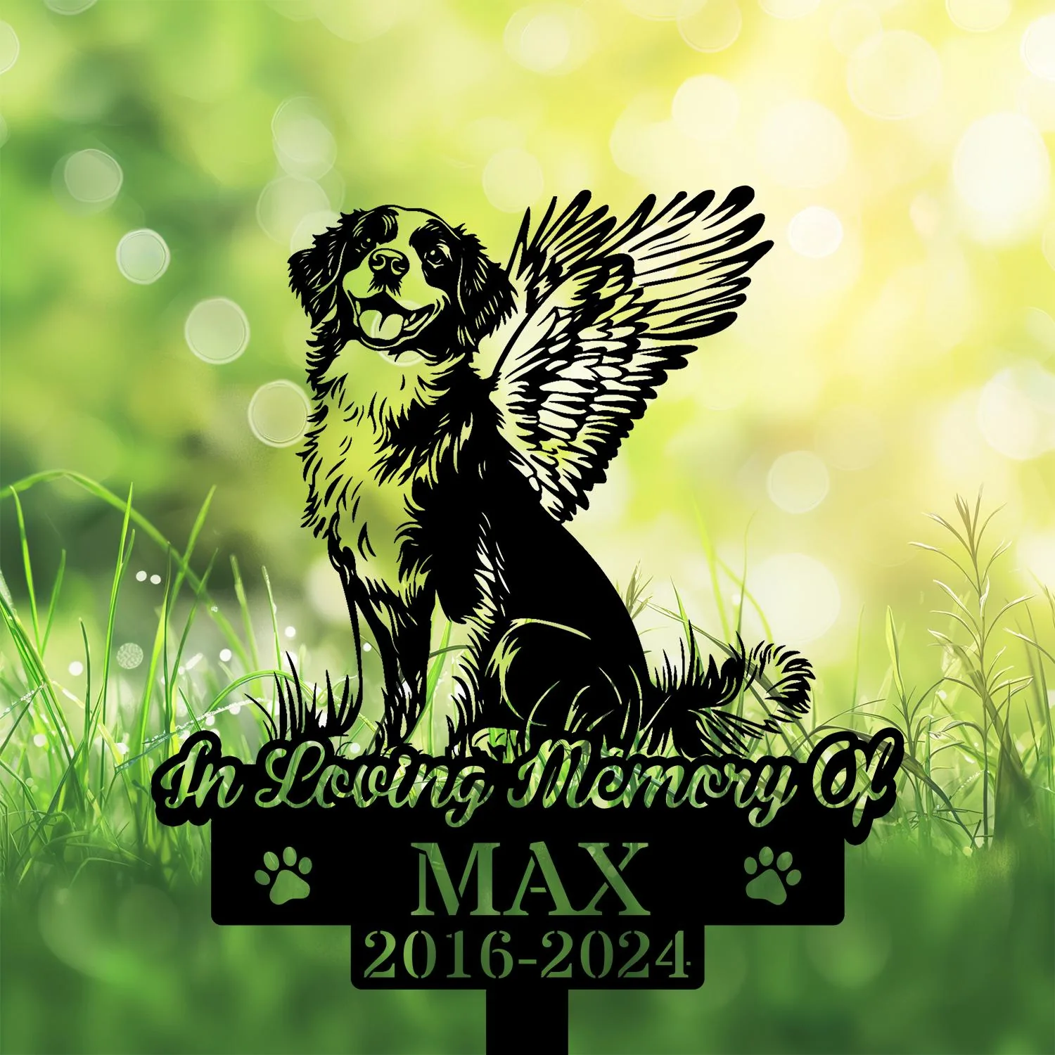 Black silhouette memorial sign of a happy winged dog sitting in grass with text “In Loving Memory Of” and name MAX 2016-2024 on a bright green bokeh background