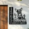 Chihuahua-Sitting-with-Butterfly-1-2 Black metal house sign mounted beside a wooden door showing address numbers 1565 and text 'FAIRWAY DRIVE' with a Chihuahua illustration, flowers and butterflies on a white wall