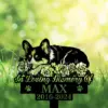 Black silhouette memorial sign of a sleeping dog among roses reading "In Loving Memory of MAX 2016-2024" against a bright green bokeh grassy background