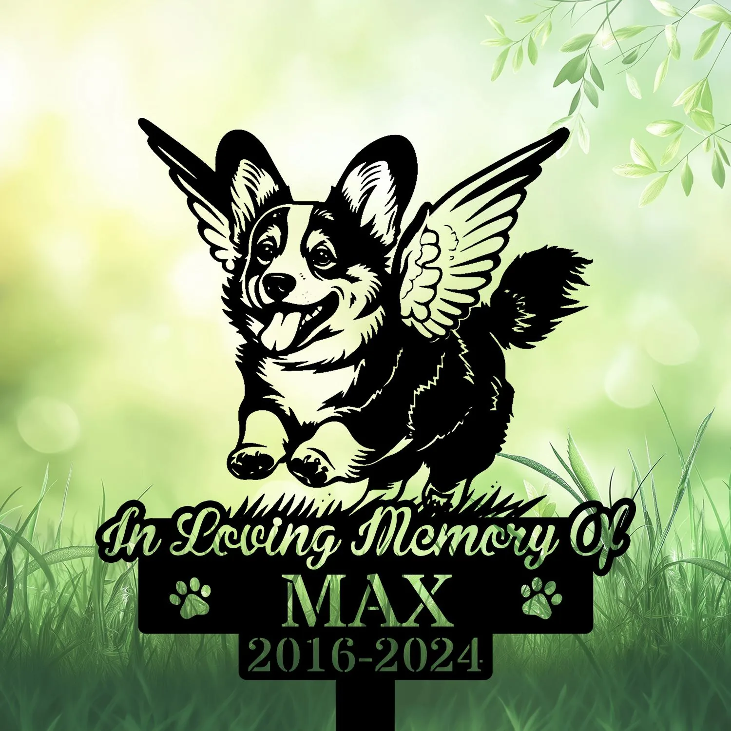 Black silhouette memorial sign of a winged corgi jumping with text “In Loving Memory Of MAX 2016-2024” against a soft green grassy background
