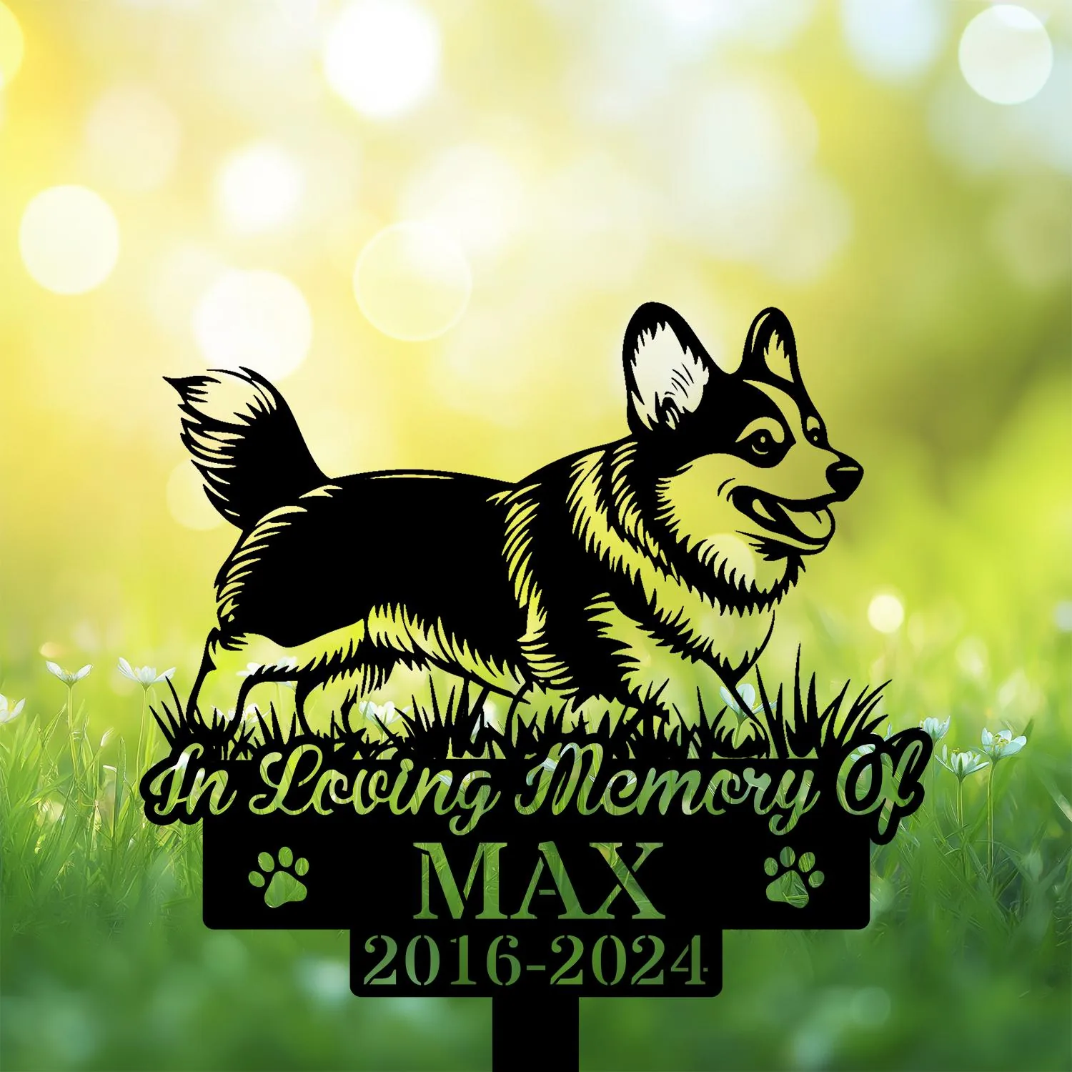 Black silhouette memorial sign of a happy corgi in grass with text "In Loving Memory Of MAX 2016-2024" against a bright bokeh green background