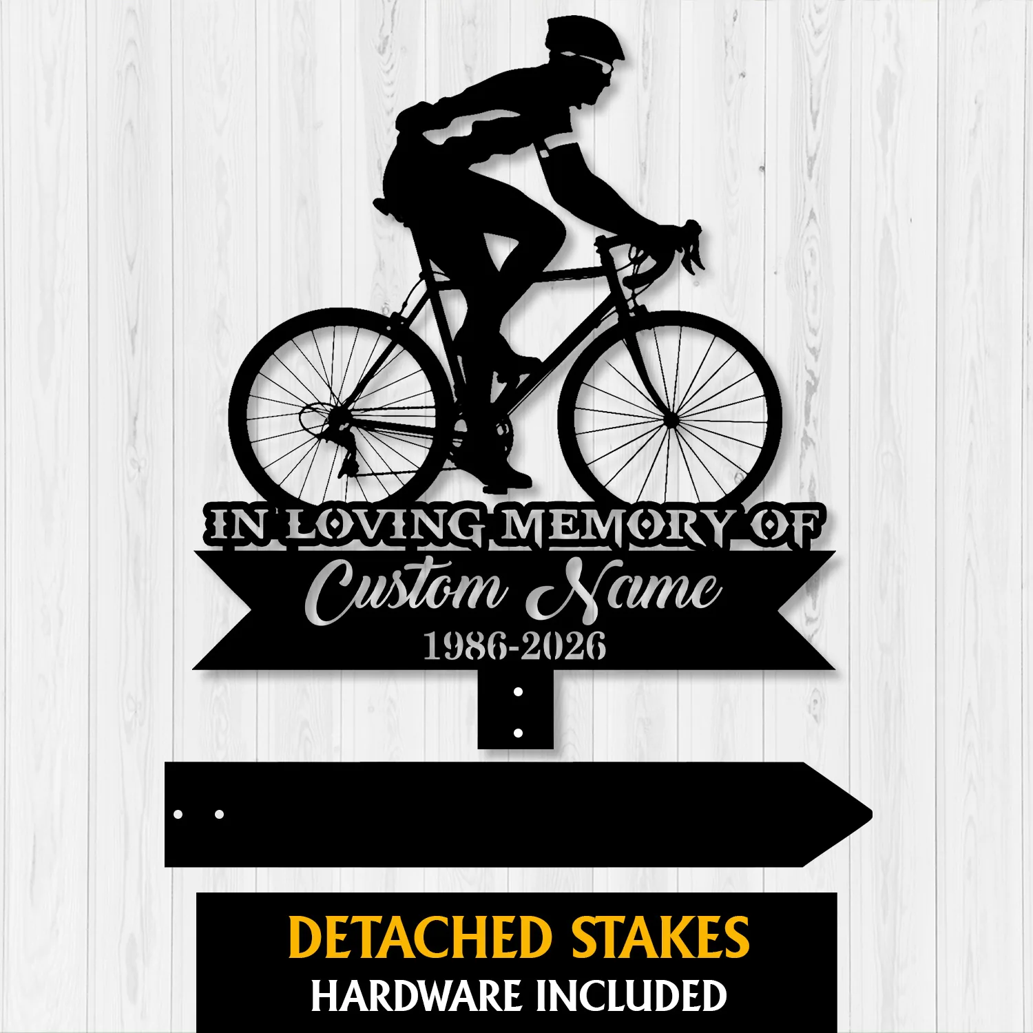 Cyclist-2 Black metal memorial sign showing a cyclist silhouette above text "In Loving Memory of" and customizable name with years 1986-2026 on a light wood background