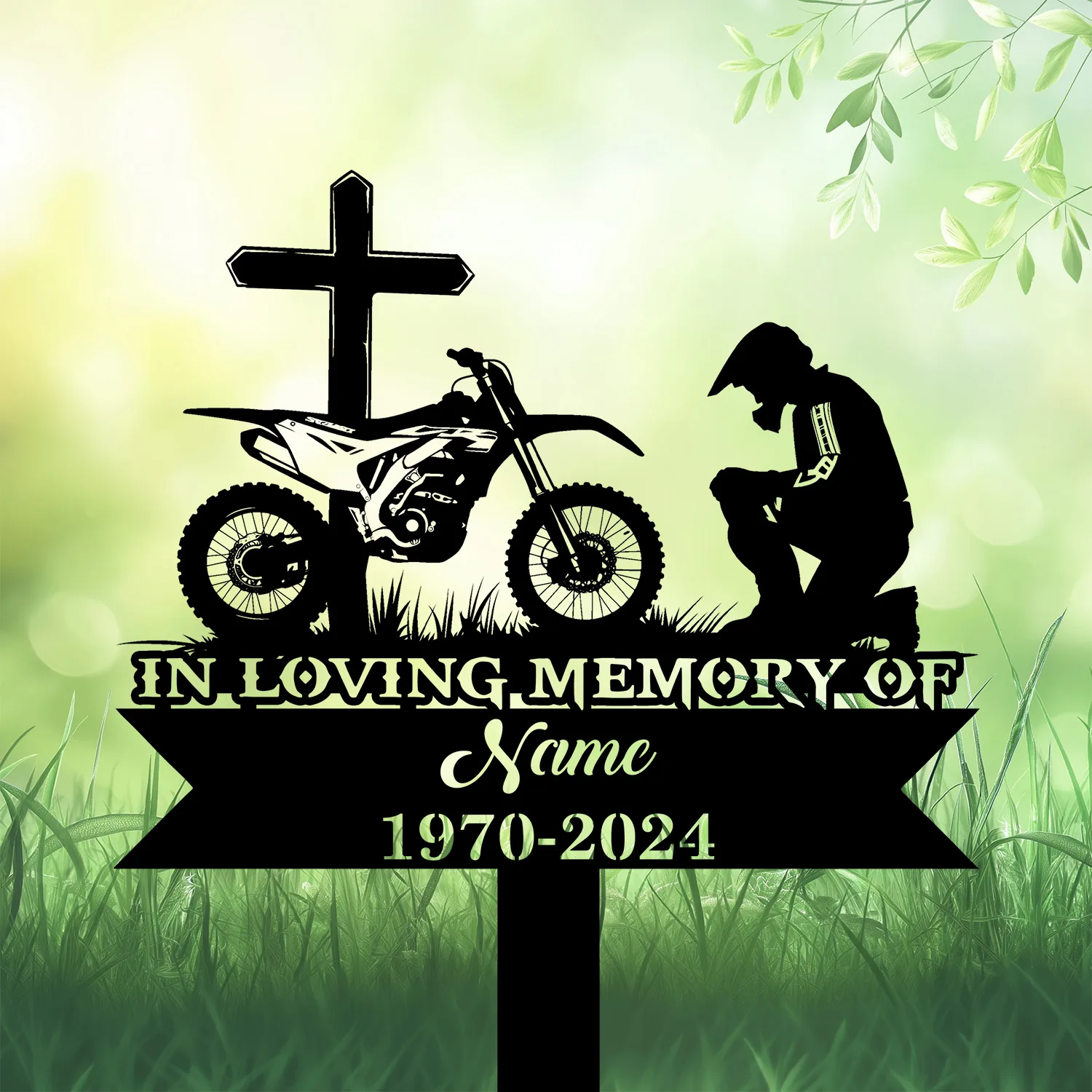 Dirtbike-Racer-Kneeling-at-Cross-3 Black silhouette memorial sign with a cross, dirt bike and kneeling rider above text ‘In Loving Memory’ and placeholder name and dates on a grassy green background
