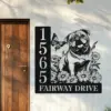 English-Bulldog-Sitting-with-Butterfly-1 Black metal house sign mounted on a light exterior wall next to a wooden door, featuring vertical address numbers 1565, text "FAIRWAY DRIVE", and a decorative pug surrounded by daisies and a butterfly