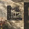 English-Bulldog-Sitting-with-Butterfly-2 Black metal house sign mounted on a brick wall showing numbers 1565, the text "FAIRWAY DRIVE," and a decorative pug with flowers and a butterfly