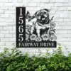English-Bulldog-Sitting-with-Butterfly-3 Black metal house number sign reading 1565 and FAIRWAY DRIVE with a cutout pug, flowers and butterfly mounted on a white brick wall above green shrubbery
