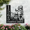 black metal house sign mounted on a white brick wall showing address 1565 and the text FAIRWAY DRIVE with a sitting golden retriever and flowers, pink garden blooms below
