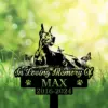 Memorial garden sign showing a reclining dog silhouette with butterflies, text "In Loving Memory Of MAX 2016-2024" against a sunlit green bokeh background