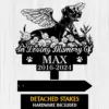 Black silhouette memorial sign with winged dog among flowers reading "In Loving Memory Of" and name MAX with dates 2016-2024, paw prints on wood background