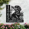 Black metal house sign mounted on a white brick wall featuring a dog with a butterfly, daisies, vertical house number 1565 and text 'FAIRWAY DRIVE' with pink flowers at the base