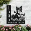 Black metal house sign mounted on a white brick wall showing numbers 1565 and text 'FAIRWAY DRIVE' with a decorative silhouette of a smiling long-haired Chihuahua among daisies and butterflies, pink flowers below.