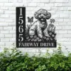 Black metal house sign mounted on a white brick wall showing numbers 1565 and the text FAIRWAY DRIVE with a carved poodle sitting among flowers and a butterfly, green shrubs below.