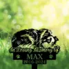 Shetland-Sheepdog-7 Black silhouette memorial sign of a dog sniffing the ground with text "In Loving Memory Of" and "MAX 2016-2024" against a bright green bokeh grass background