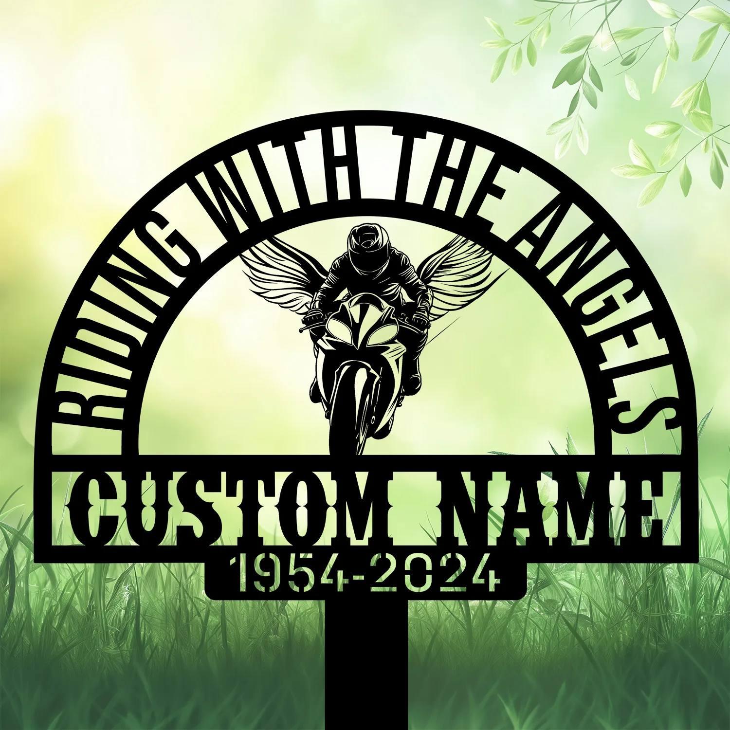 Sport-Biker-Riding-with-Angels-3 Black metal memorial sign reading "Riding With The Angels" with winged motorcyclist silhouette, placeholder "CUSTOM NAME" and dates 1954–2024 against a soft green grassy background