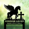 Silhouette of a winged horse next to a cross on a grave marker with text reading "FOREVER LOVED" and placeholder name and dates against a soft green nature background