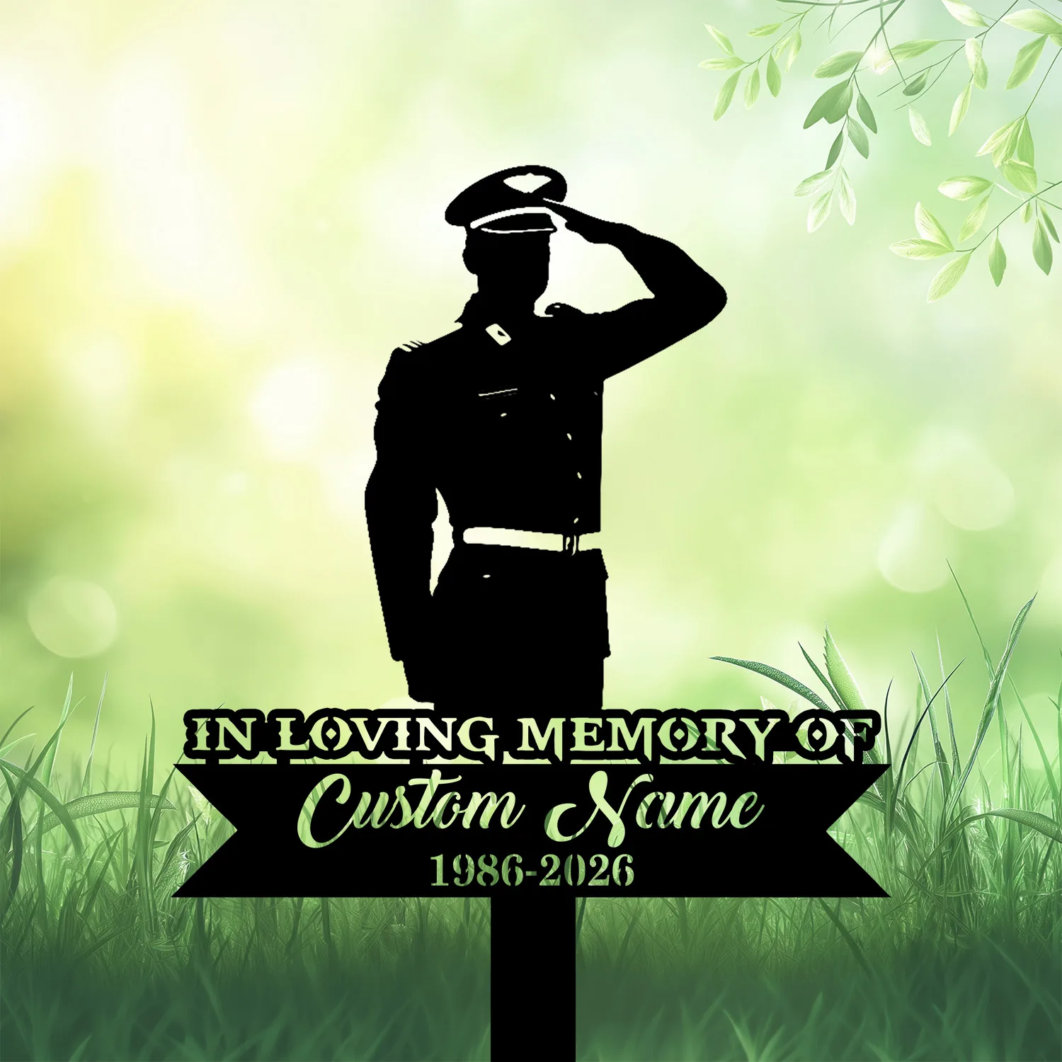 Silhouette of a saluting soldier on a memorial sign reading "In Loving Memory of Custom Name 1986-2026" against a soft green grassy background