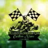 Black silhouette of a go-kart racer with crossed checkered flags and text reading "In Loving Memory Custom Name 1986-2026" on a green grassy blurred background