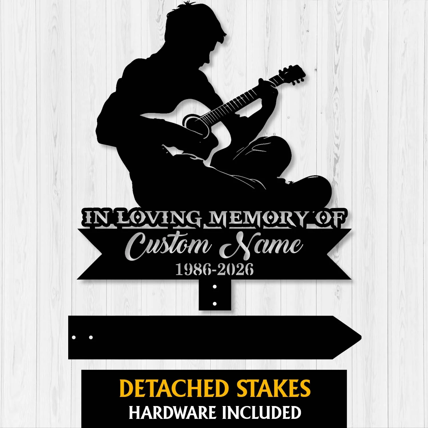 Black silhouette metal memorial sign of a seated person playing guitar with text "In Loving Memory Of" and customizable name and years on a wood panel background