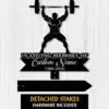 Black silhouette memorial sign showing a weightlifter holding a barbell above text 'In Loving Memory of Custom Name 1986-2026' on a light wood background