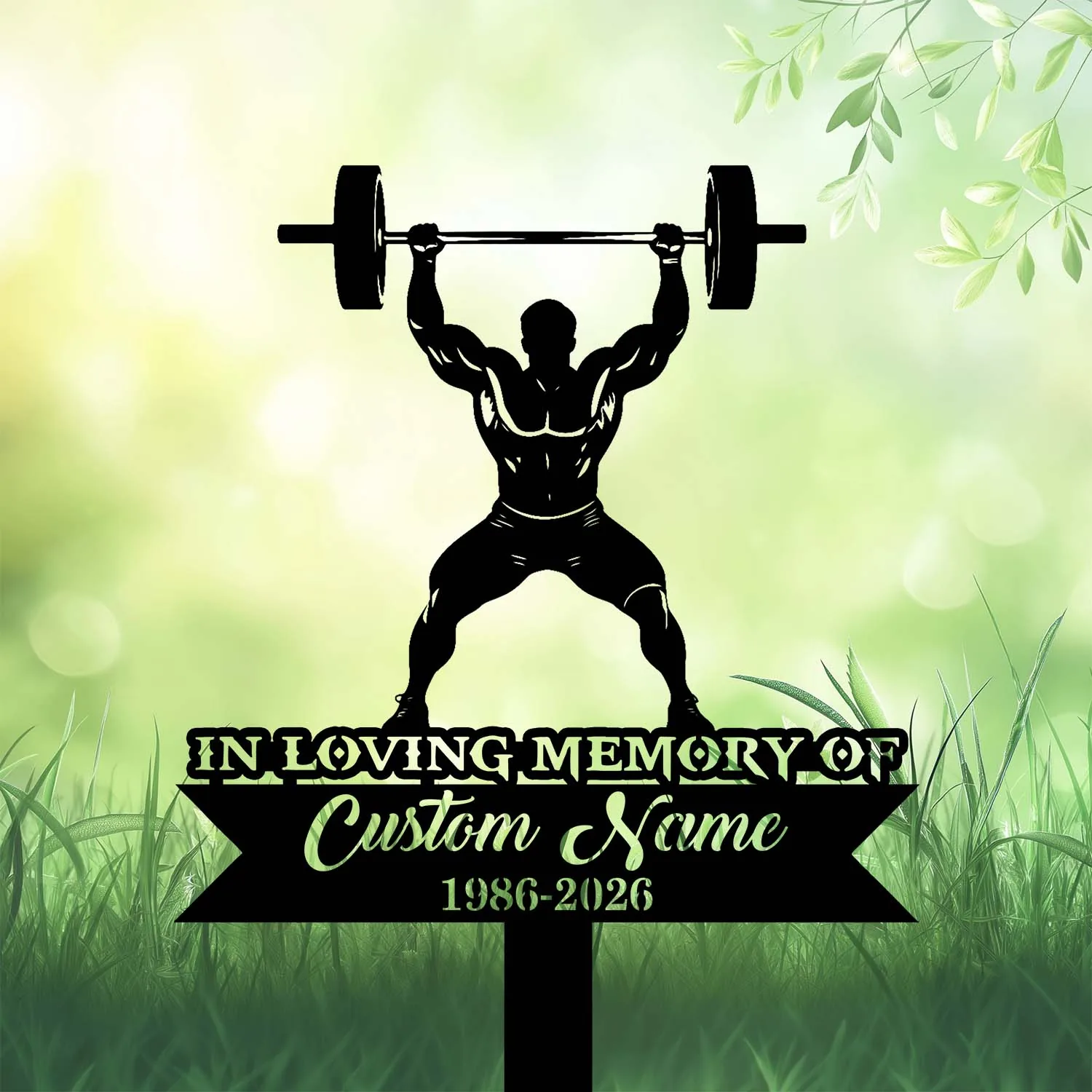 Black silhouette of a weightlifter holding a barbell above his head on a memorial sign reading "In Loving Memory" with customizable name and years against a green grassy background