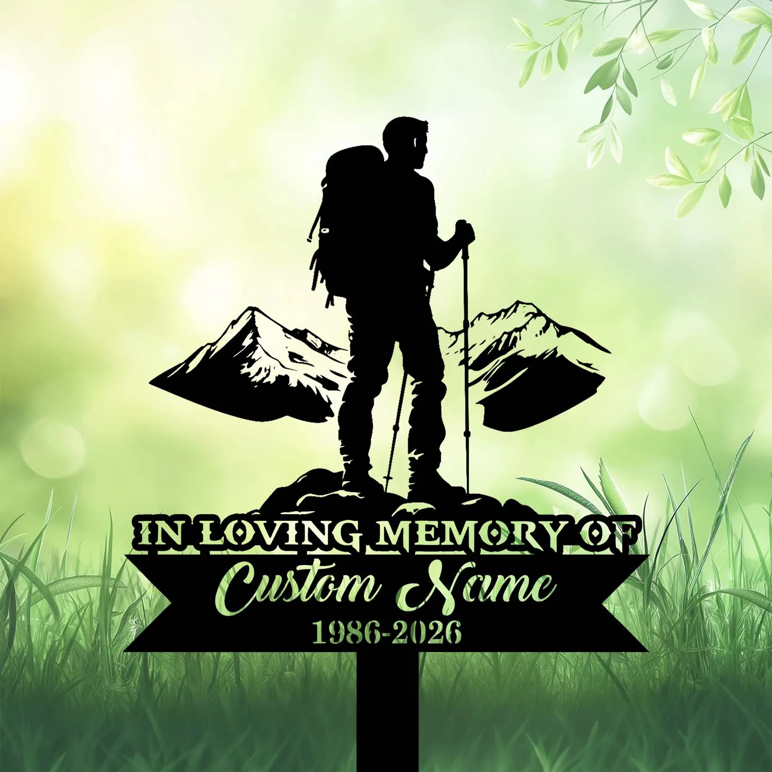 Black silhouette grave sign of a hiker with backpack and poles in front of mountains reading "In Loving Memory of Custom Name 1986-2026" on a green grassy background