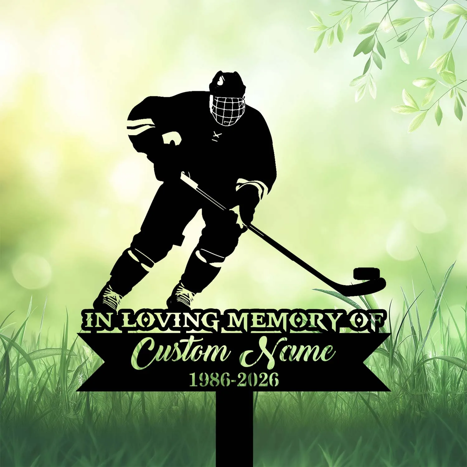 Silhouette of a hockey player with stick and puck above a memorial sign reading "In Loving Memory Custom Name 1986-2026" on grassy green background