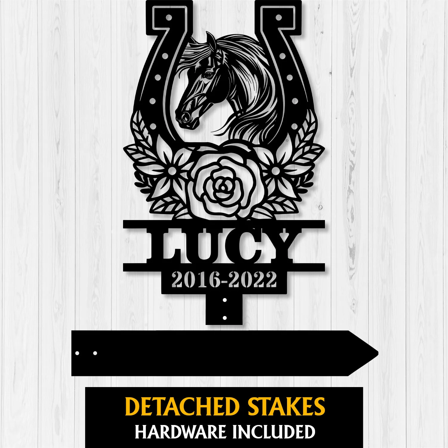 Style-20-horse-head-2-2 Black metal memorial stake with a horse head inside a horseshoe, floral wreath, the name LUCY and dates 2016-2022 on a white wood background