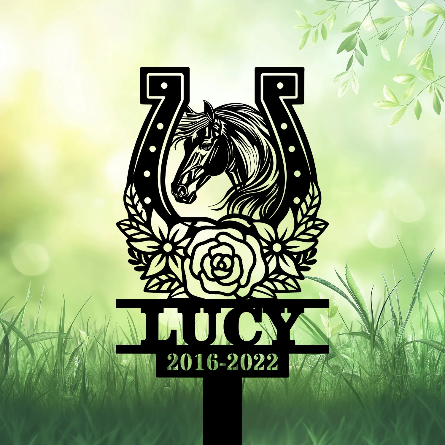 Style-20-horse-head-2-3 Black silhouette memorial stake with a horse head inside a horseshoe, floral wreath, the name LUCY and dates 2016-2022 on a grassy green background