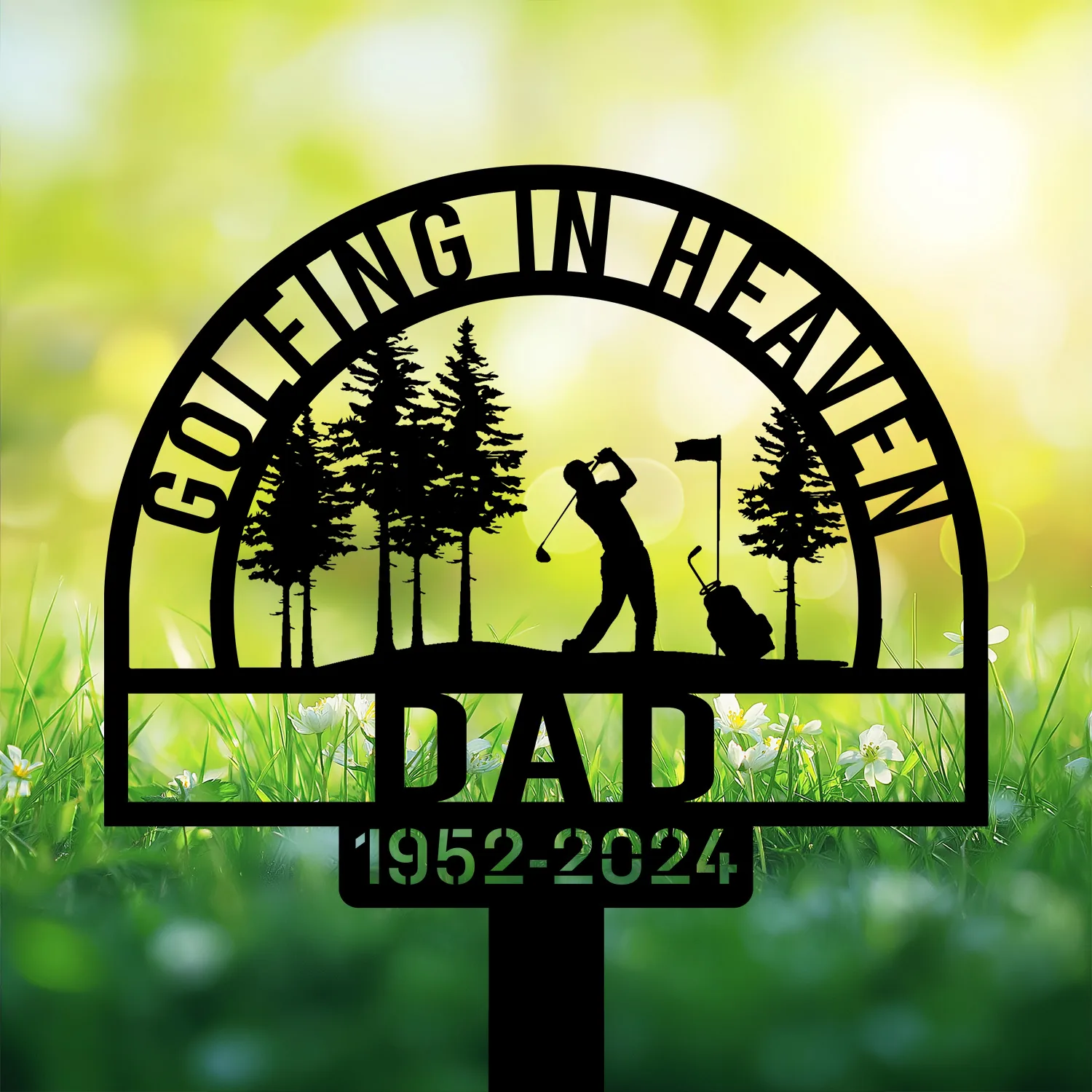 Black memorial yard sign silhouette of a golfer swinging among trees with flag, text 'Golfing in Heaven' and 'Dad 1952-2024' against a sunny green field