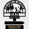 Black metal memorial sign with golfer silhouette, trees, the word DAD and dates 1952-2024 on a light wood background